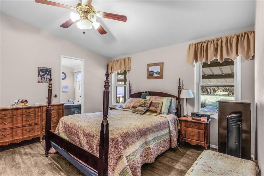 1849 Floyd Road Weatherford, TX 76087 - Photo 25 of 40 a bedroom with a bed and a chandelier