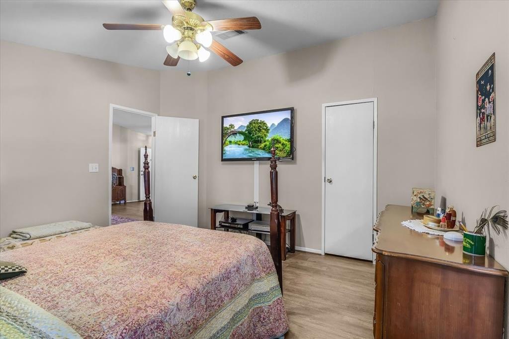 1849 Floyd Road Weatherford, TX 76087 - Photo 26 of 40 a bedroom with a bed and a chandelier