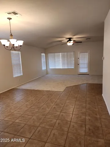 a view of a livingroom with a ceiling fan and window
