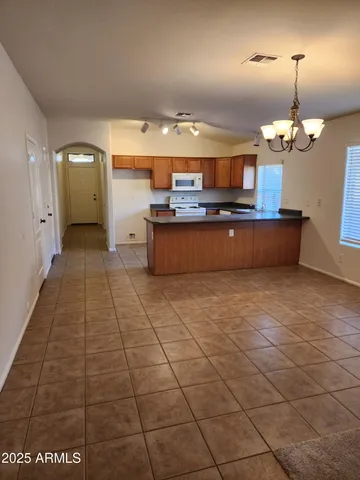 a large kitchen with stainless steel appliances a sink a counter space and cabinets
