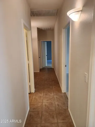 a view of a hallway with a glass door and a window