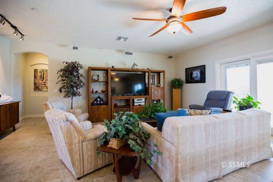 2401 Lacey Street Ridgecrest, CA 93555 - Photo 16 of 44 a living room with furniture and a flat screen tv