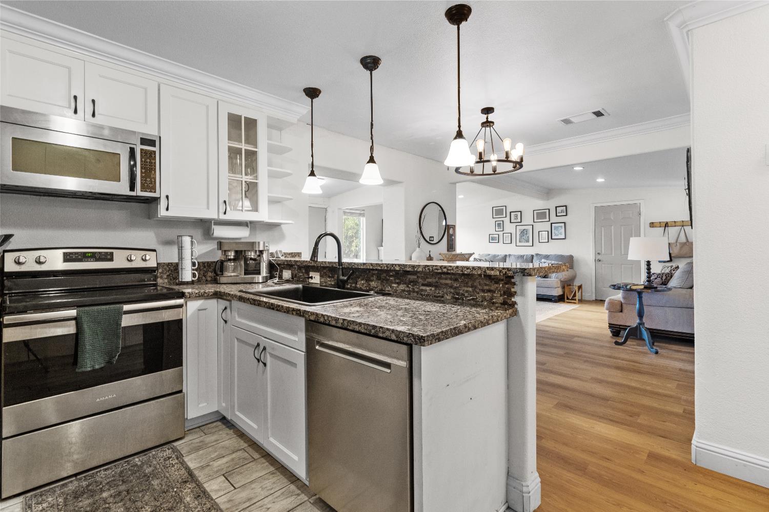 3319 U Street Antelope, CA 95843 - Photo 1 of 14 a kitchen with a stove and a wooden floor