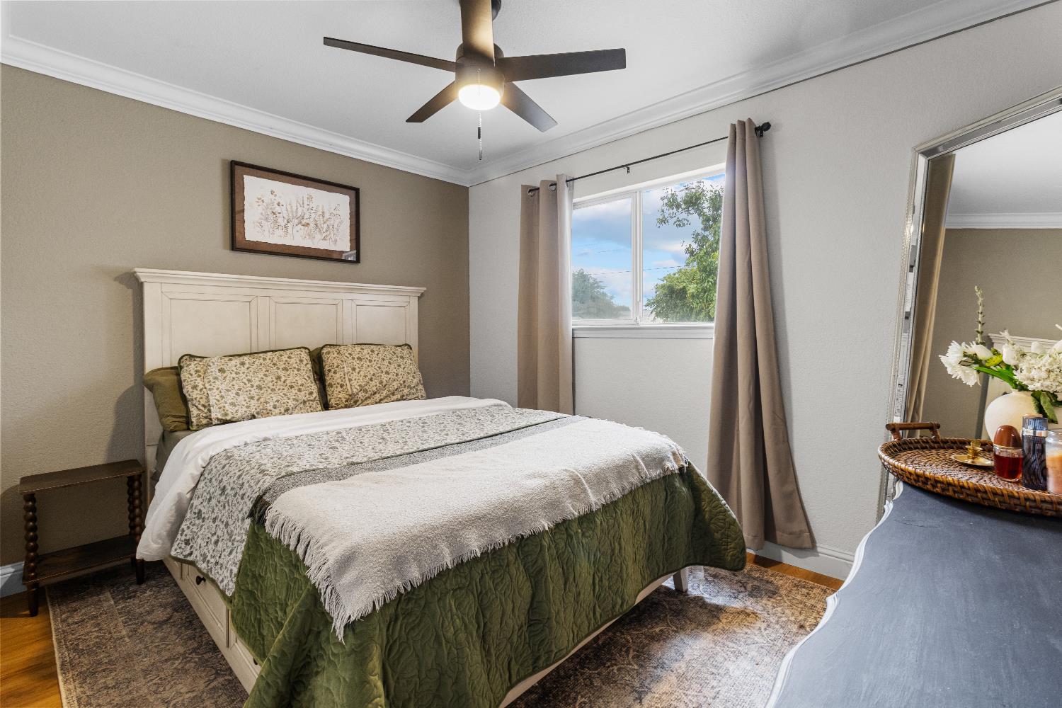 3319 U Street Antelope, CA 95843 - Photo 11 of 14 a bedroom with a bed a painting on the wall and a dresser