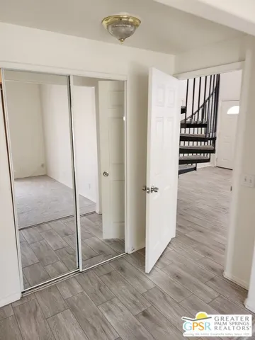 a view of a yard with plants and trees