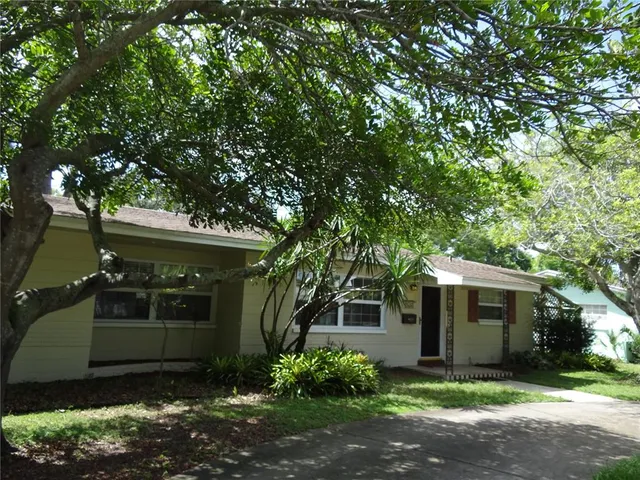 a front view of house with small garden