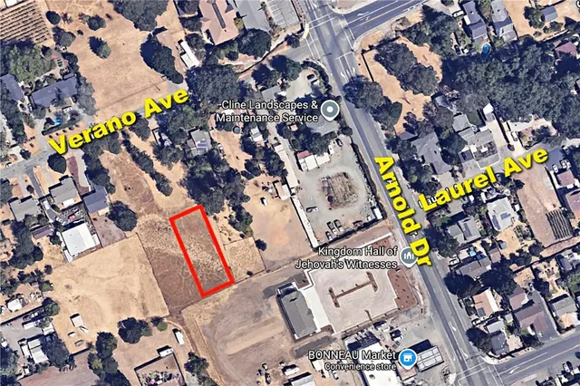 a view of a green field with lots of bushes