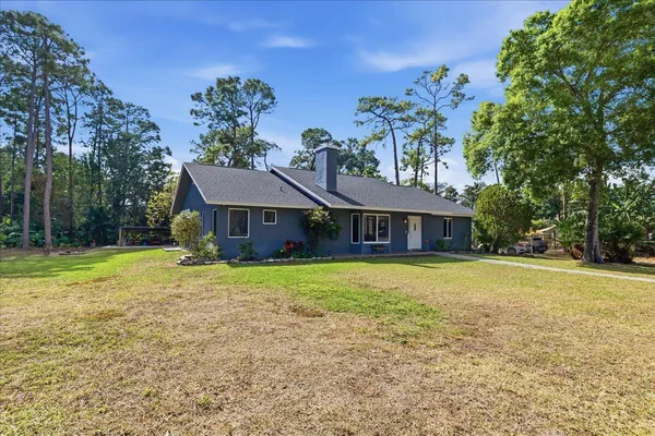 a front view of a house with garden