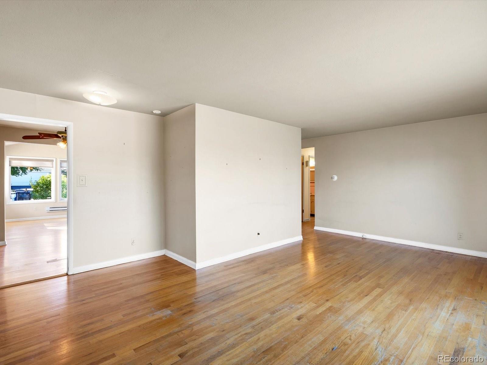 9815 West 37th Avenue Wheat Ridge, CO 80033 - Photo 3 of 50 a view of an empty room with wooden floor