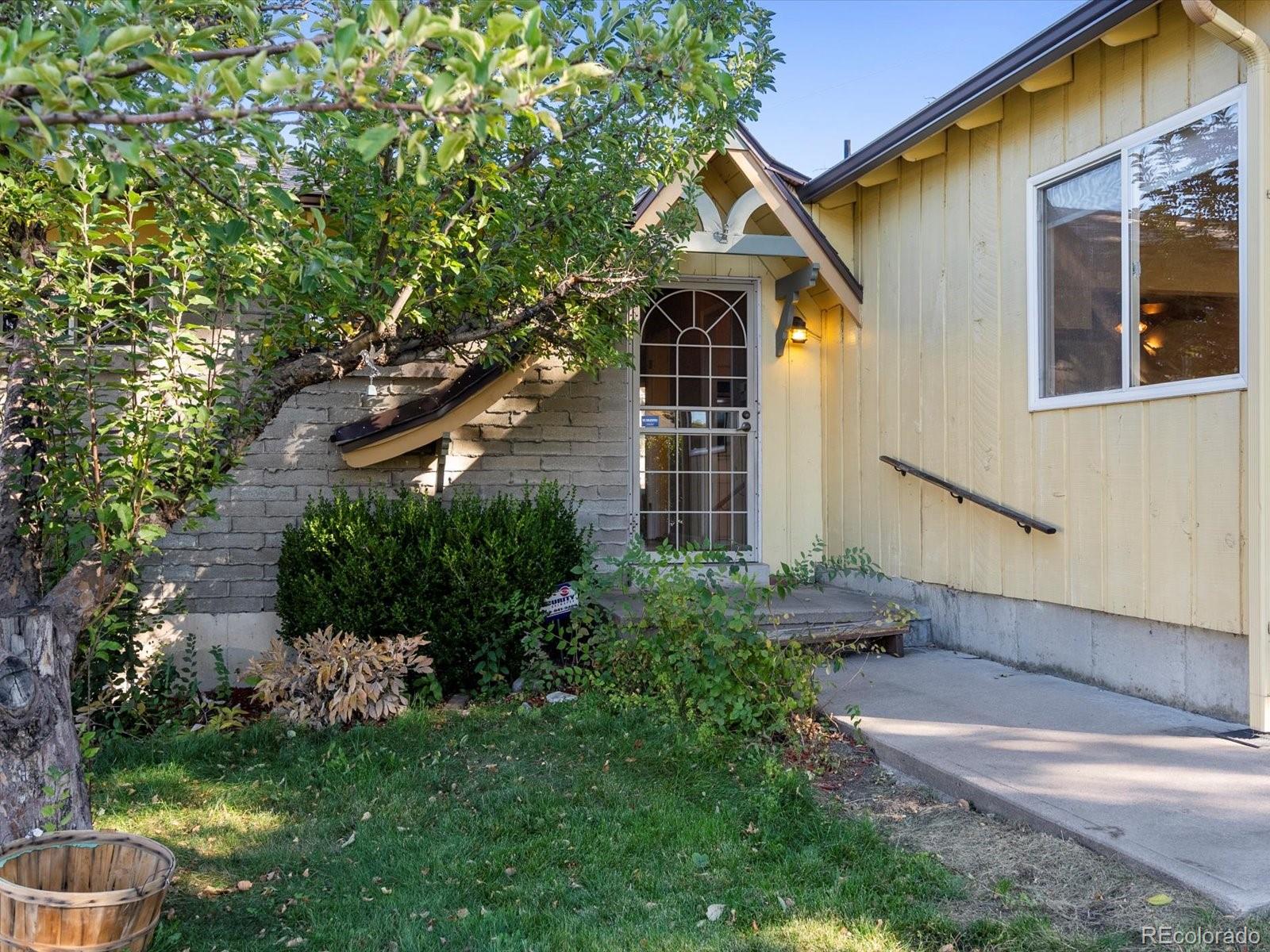 9815 West 37th Avenue Wheat Ridge, CO 80033 - Photo 31 of 50 a front view of a house with a yard