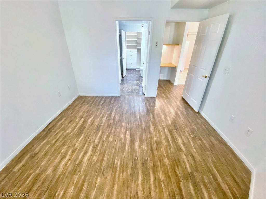 10550 West Alexander Road, Unit 1131 Las Vegas, NV 89129 - Photo 11 of 18 Laminate flooring extends throughout this versatile space, featuring convenient built-in shelving.