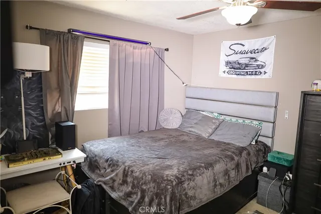 a bed sitting in a bedroom next to a window