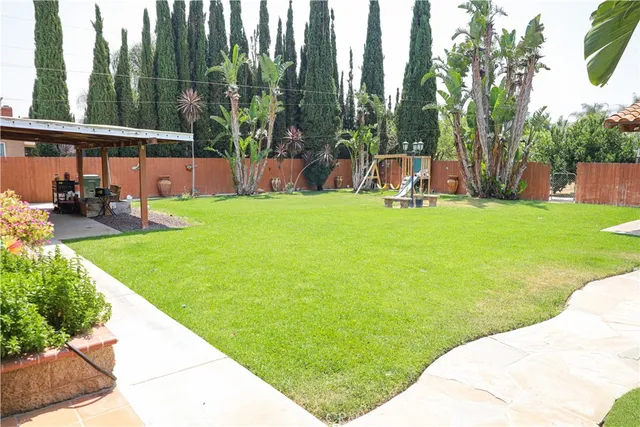 a view of a backyard with sitting area