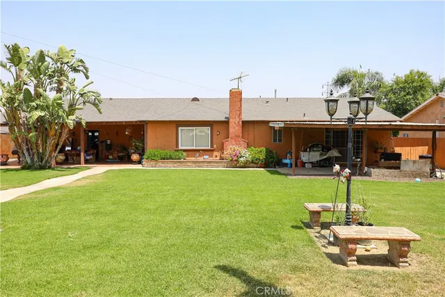 a front view of house with a garden and patio