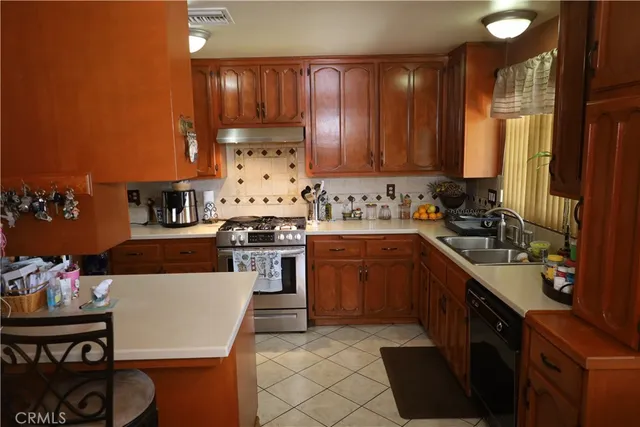 a kitchen with a sink stove and cabinets