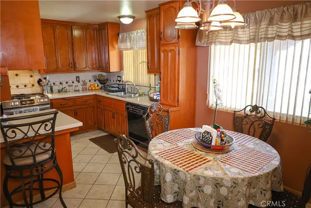 a kitchen with stainless steel appliances a dining table and chairs