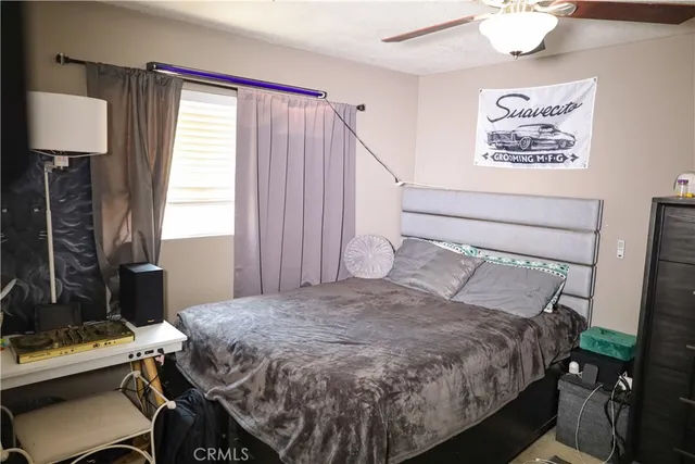 a bed sitting in a bedroom next to a window