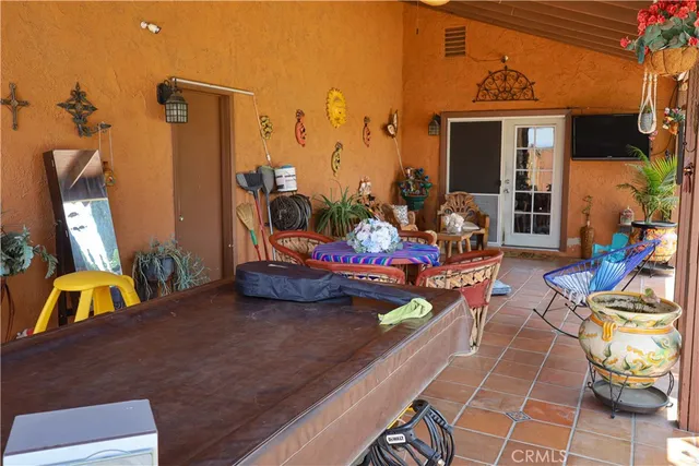 a view of a balcony with chairs and a potted plant