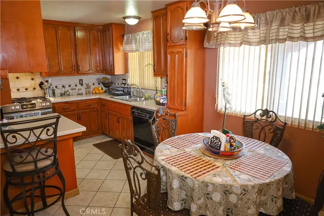 a kitchen with stainless steel appliances a dining table and chairs