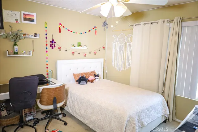 a bedroom with a bed and a chair