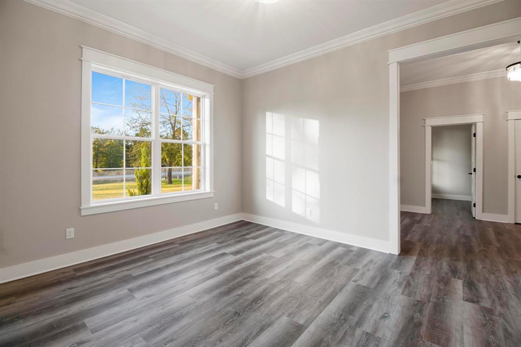 800 Stone Chimney Road Bullard, TX 75757 - Photo 11 of 40 a view of an empty room with wooden floor and a window