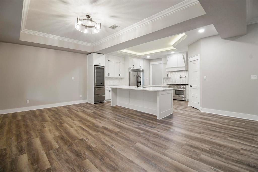 800 Stone Chimney Road Bullard, TX 75757 - Photo 12 of 40 a view of a kitchen with wooden floor and a ceiling fan