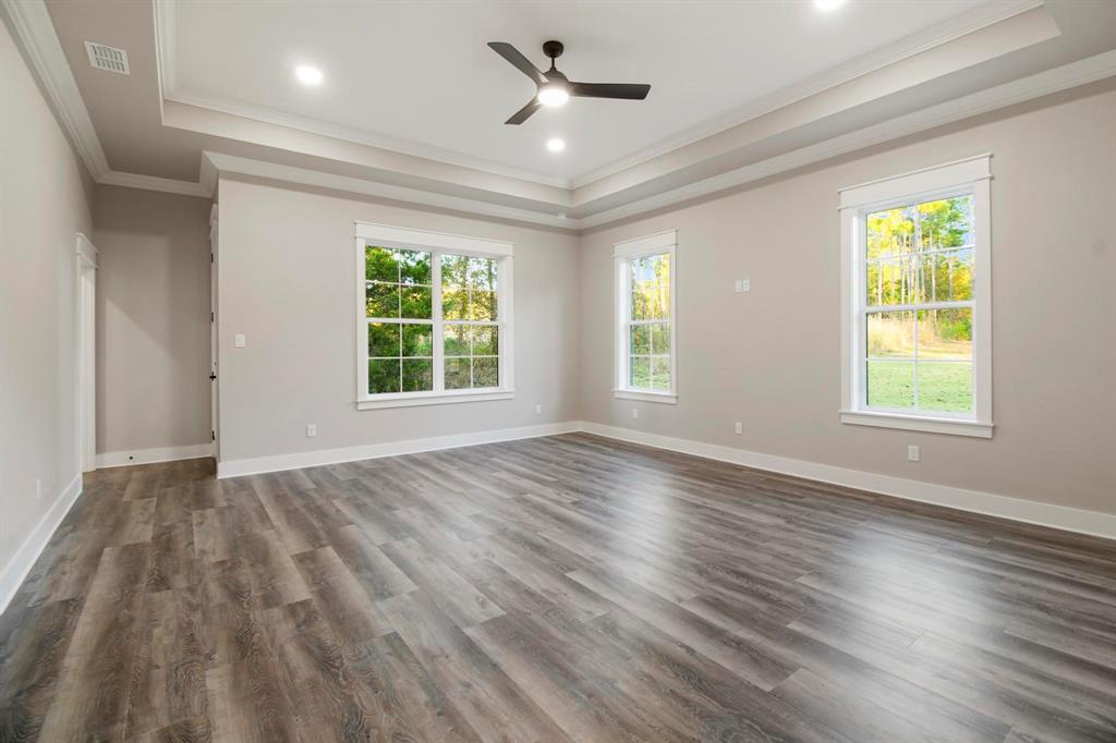 800 Stone Chimney Road Bullard, TX 75757 - Photo 17 of 40 a view of an empty room with wooden floor and a window