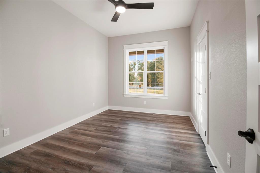 800 Stone Chimney Road Bullard, TX 75757 - Photo 21 of 40 an empty room with wooden floor fan and windows