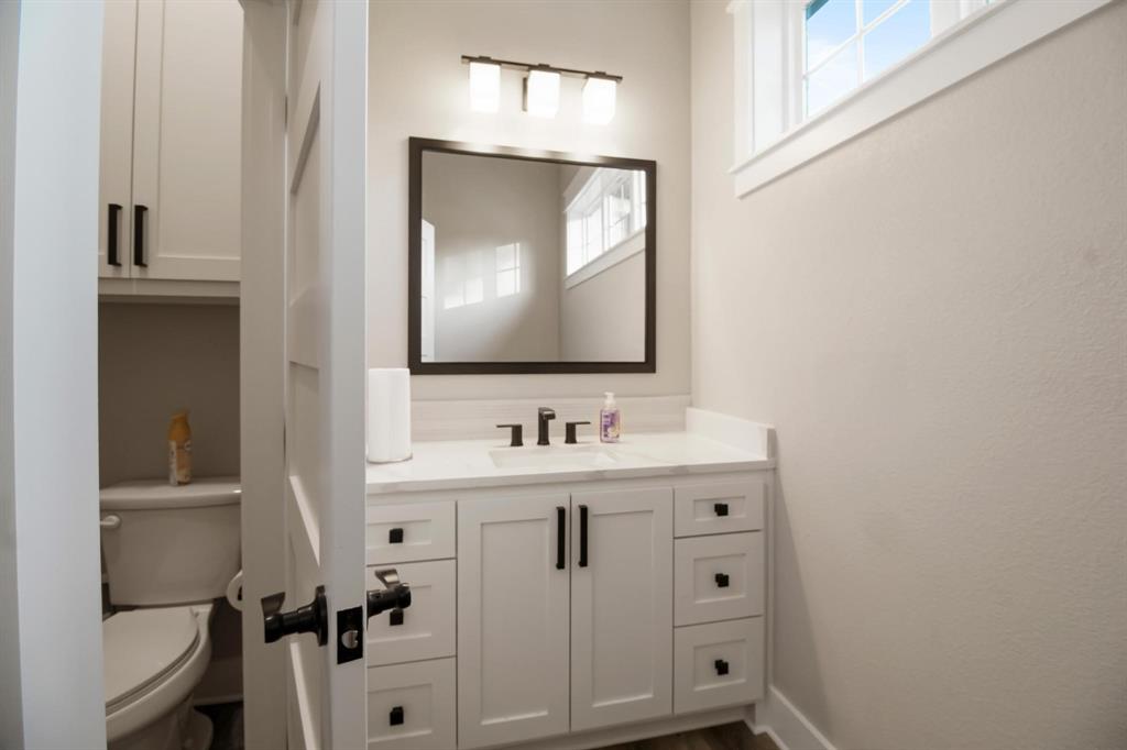 800 Stone Chimney Road Bullard, TX 75757 - Photo 28 of 40 a bathroom with a toilet sink and mirror