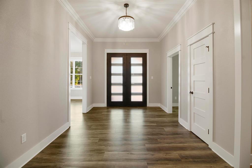 800 Stone Chimney Road Bullard, TX 75757 - Photo 9 of 40 a view of an empty room with window and wooden floor