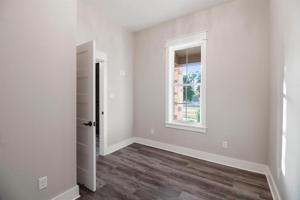 800 Stone Chimney Road Bullard, TX 75757 - Photo 10 of 40 an empty room with wooden floor and a window