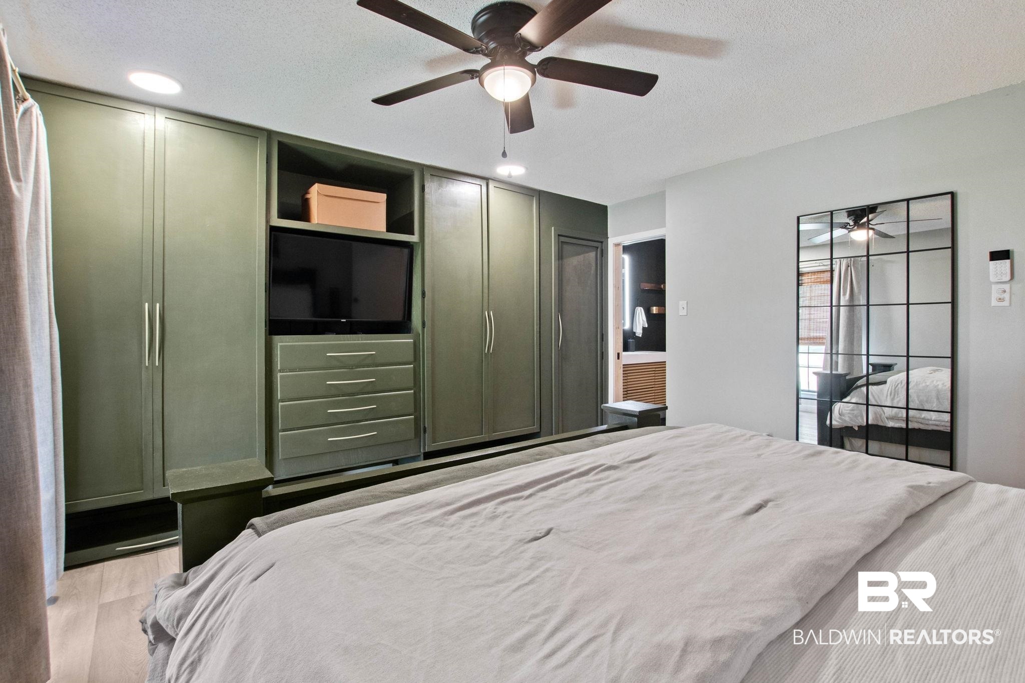 524 Ariel Avenue Foley, AL 36535 - Photo 16 of 37 Built-in olive-toned cabinetry system with integrated shelving and drawers, wood-finish flooring, recessed lighting, and a ceiling fan