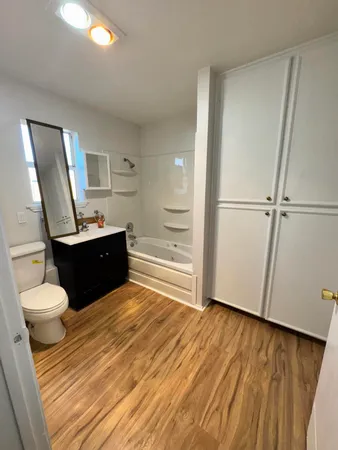 a bathroom with a sink mirror vanity and toilet