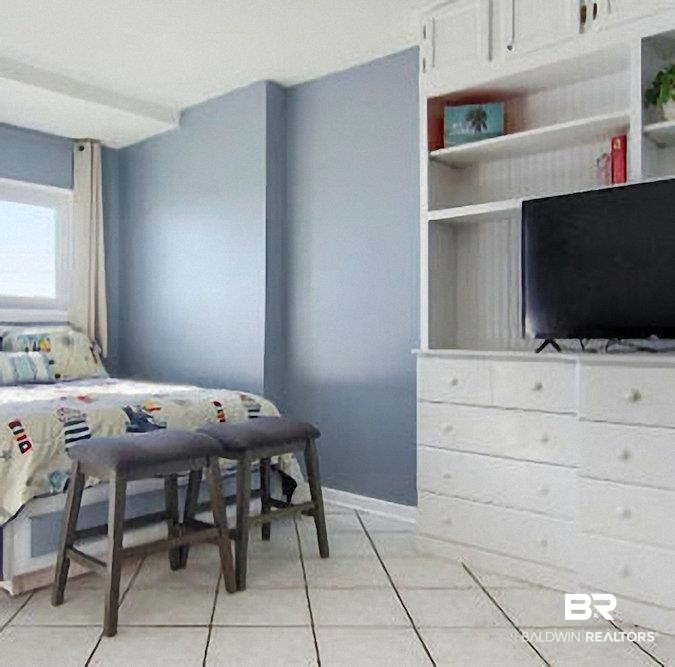 375 Plantation Road, Unit 5602 Gulf Shores, AL 36542 - Photo 2 of 11 White tile flooring complemented by a built-in storage unit with open shelving and closed cabinetry