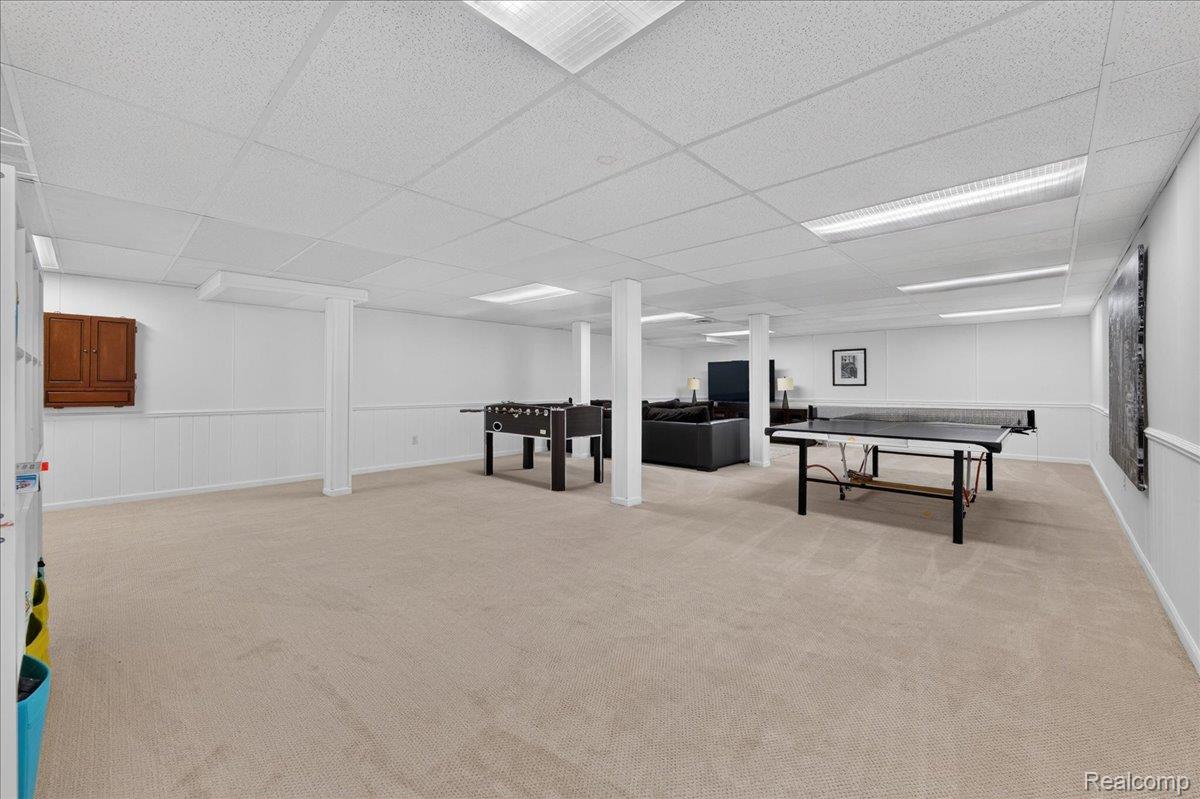 7330 West Gates Street Romeo, MI 48065 - Photo 46 of 73 Expansive open-concept space featuring carpeted flooring, drop ceiling with integrated lighting, and wainscoting on perimeter walls
