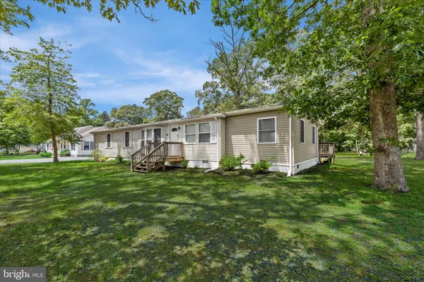 a kitchen with stainless steel appliances granite countertop a refrigerator a sink and a stove
