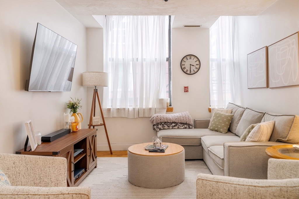 a living room with furniture and a large window