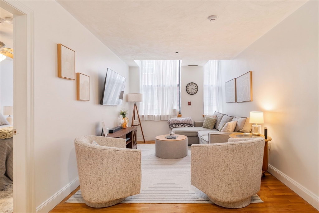 188 North Street, Unit 22 Boston, MA 02113 - Photo 2 of 18 a living room with furniture and a flat screen tv