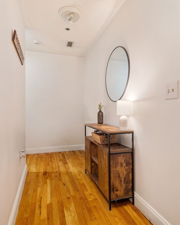 188 North Street, Unit 22 Boston, MA 02113 - Photo 5 of 18 a view of a room with wooden floor and white walls