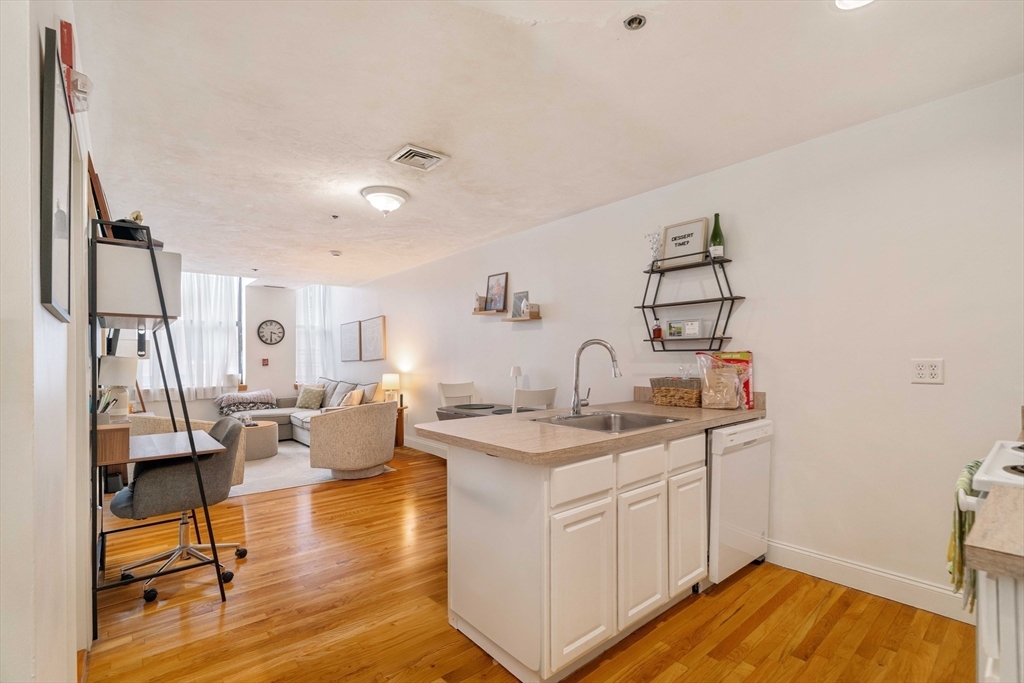 188 North Street, Unit 22 Boston, MA 02113 - Photo 7 of 18 a living room with kitchen island furniture and a wooden floor
