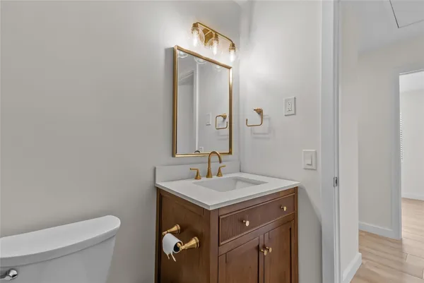 a bathroom with a sink toilet and mirror