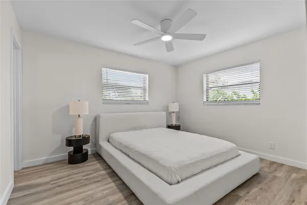 a bedroom with a bed and a window