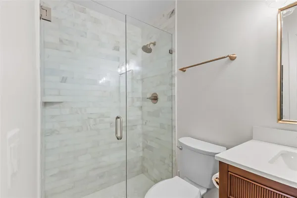 a bathroom with a toilet and a shower