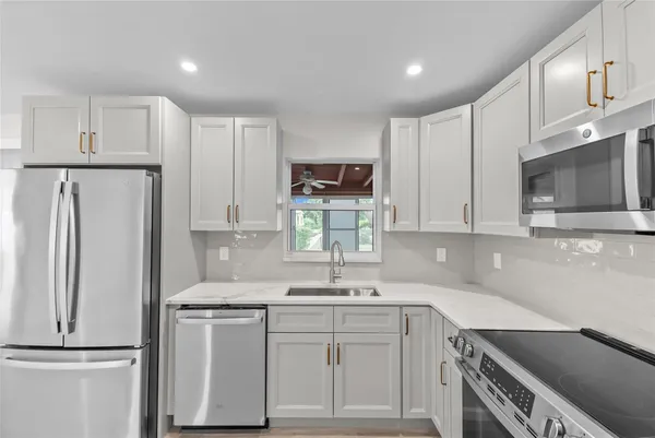 a kitchen with a sink cabinets and stainless steel appliances