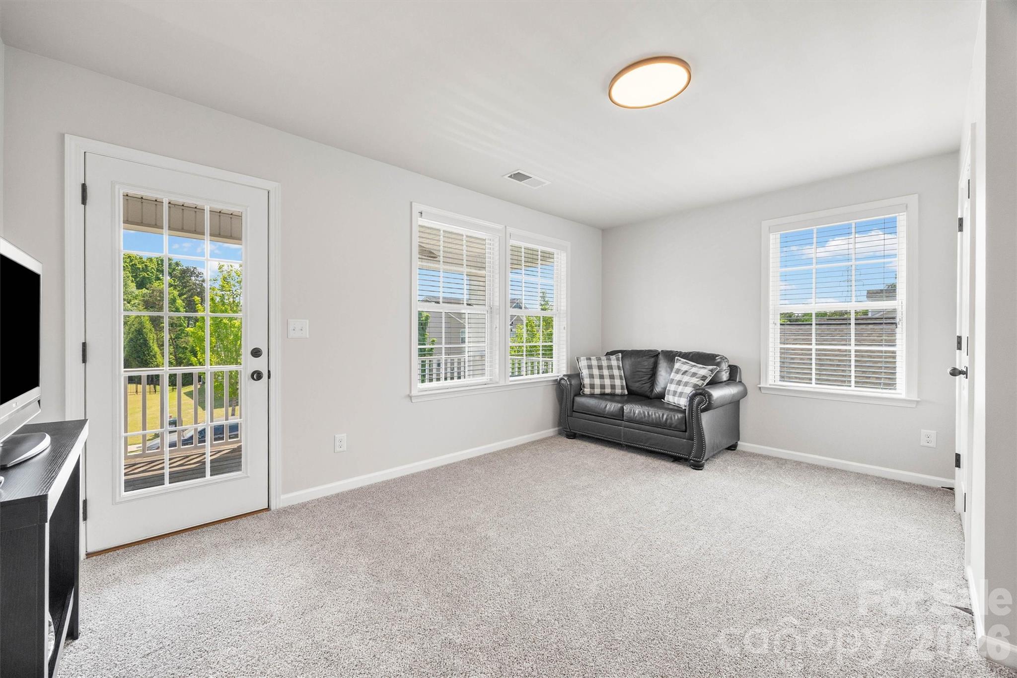 299 Annatto Way Tega Cay, SC 29708 - Photo 27 of 46 a living room with furniture and a flat screen tv