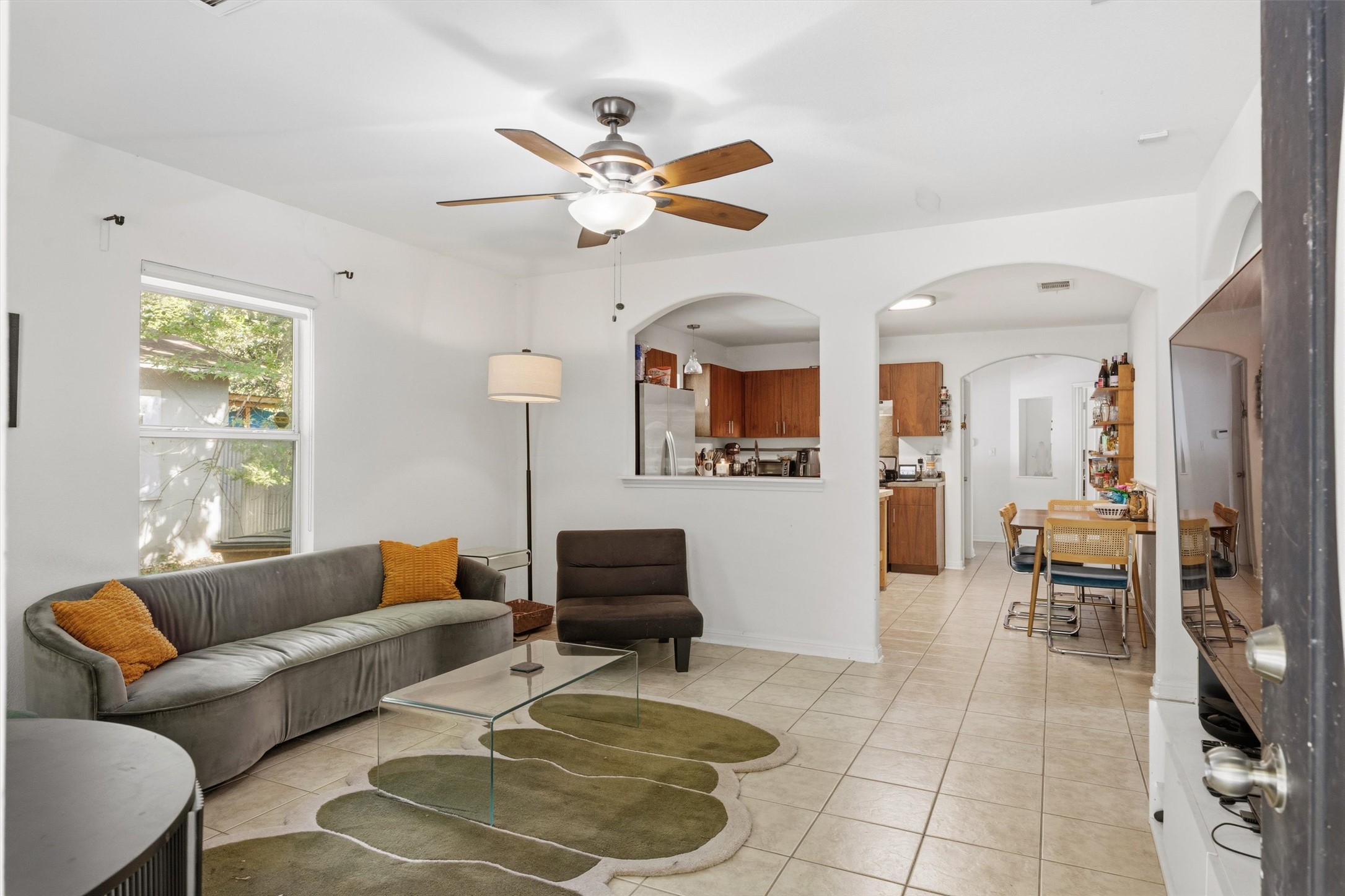 3015 Castro Street Austin, TX 78702 - Photo 6 of 40 An inviting living area with a ceiling fan, seamlessly connecting to the kitchen and dining space.