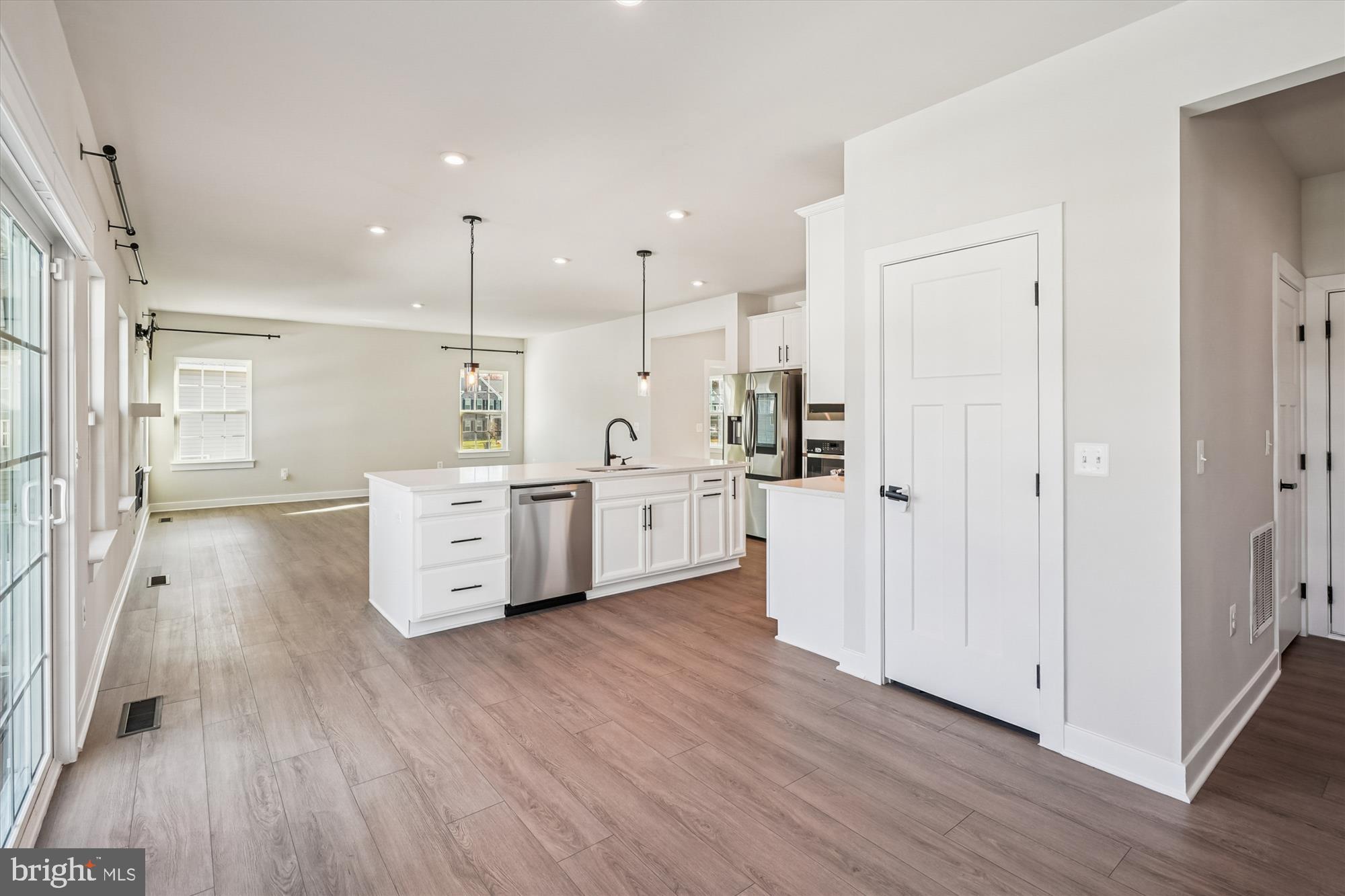 105 Driscoll Lane Stafford, VA 22554 - Photo 17 of 69 a room with stainless steel appliances kitchen island wooden floors and white walls