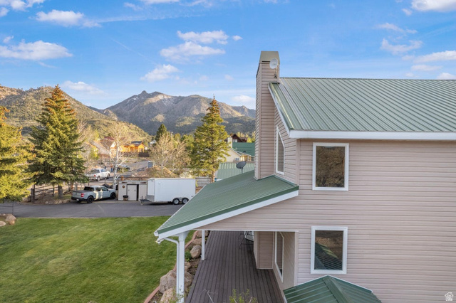 48 South Sage Road Pine Valley, UT 84781 - Photo 12 of 61 Exterior featuring a green metal roof, light-colored horizontal siding, and multiple windows