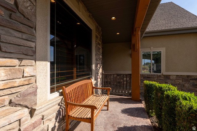 687 South 2080th Street East Springville, UT 84663 - Photo 126 of 149 Covered entryway featuring stone veneer, stucco siding, and a stamped concrete path
