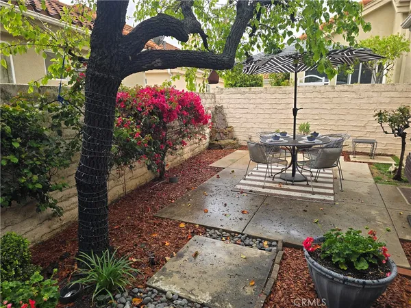 a view of a tables and chairs and potted plants